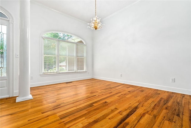 1421 Crossing Way, Auburn, AL 36830 - empty room with crown molding, a chandelier, wood finished floors, and decorative columns