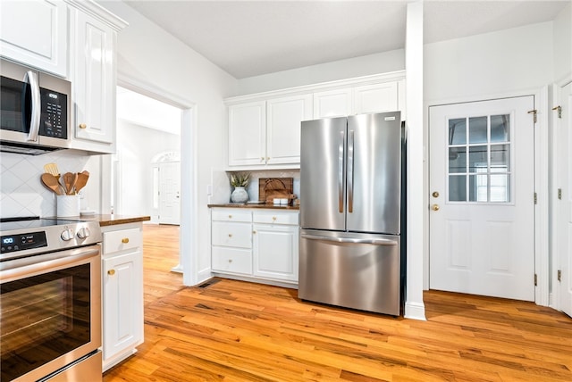 1421 Crossing Way, Auburn, AL 36830 - kitchen featuring appliances with stainless steel finishes, light wood-style flooring, white cabinetry, and backsplash