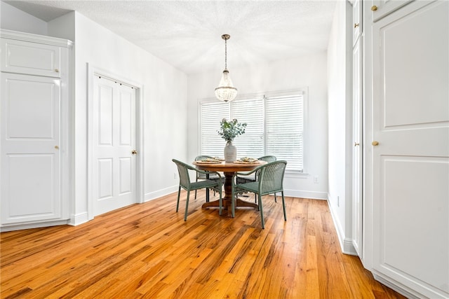 1421 Crossing Way, Auburn, AL 36830 - dining space featuring light wood-type flooring and a chandelier