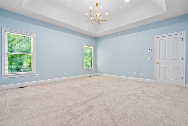 1421 Crossing Way, Auburn, AL 36830 - carpeted empty room with a raised ceiling and a chandelier