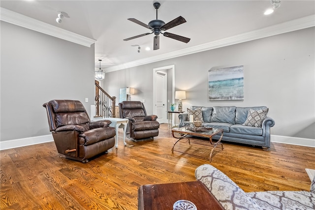 living room with crown molding, wood-type flooring, and ceiling fan with notable chandelier