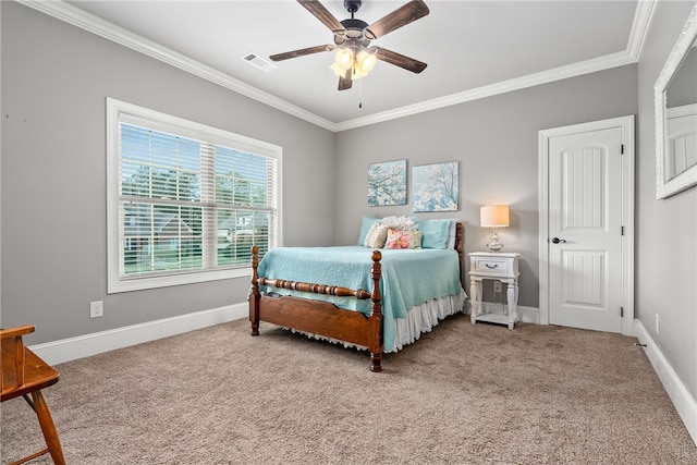 carpeted bedroom featuring ceiling fan and crown molding