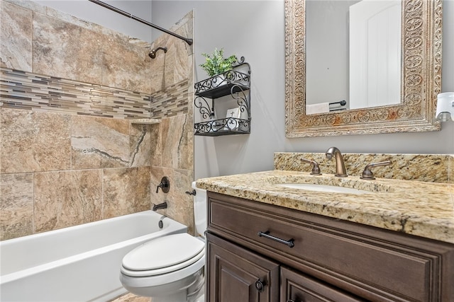 full bathroom with toilet, vanity, and tiled shower / bath