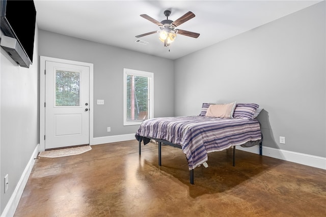 bedroom featuring ceiling fan and concrete floors