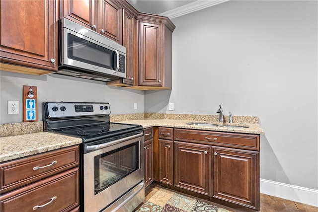 kitchen featuring crown molding, sink, light tile patterned floors, appliances with stainless steel finishes, and light stone counters