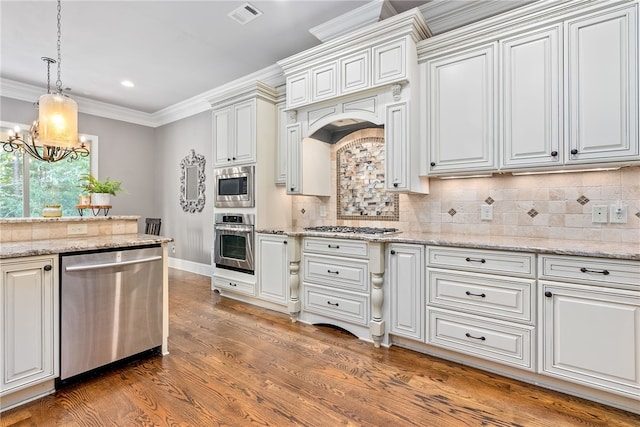 kitchen with light stone countertops, a notable chandelier, decorative backsplash, white cabinets, and appliances with stainless steel finishes