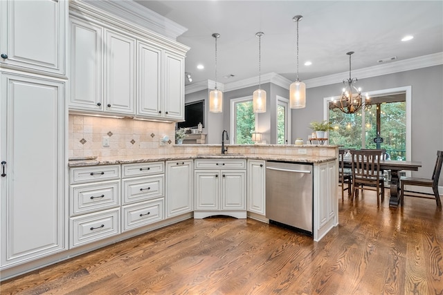 kitchen featuring backsplash, white cabinets, sink, an inviting chandelier, and dishwasher