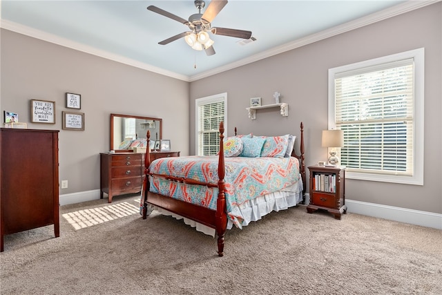 carpeted bedroom with ceiling fan and ornamental molding