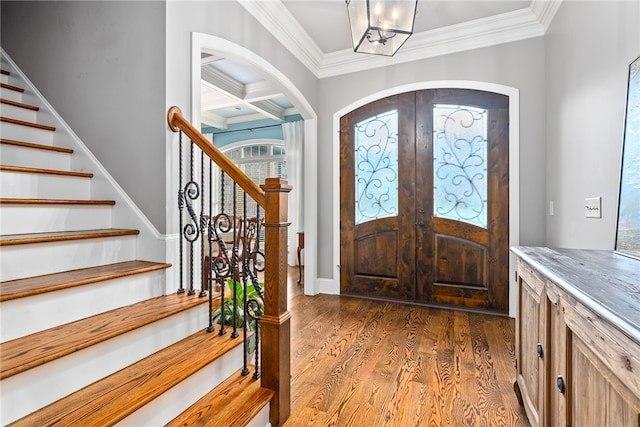 foyer entrance with french doors, dark hardwood / wood-style flooring, coffered ceiling, crown molding, and beam ceiling