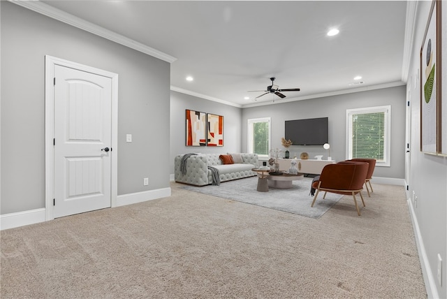 carpeted living room featuring ceiling fan and ornamental molding