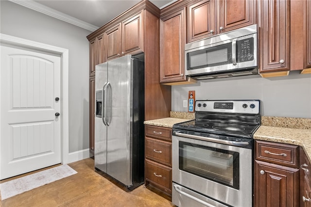 kitchen featuring appliances with stainless steel finishes, light stone counters, ornamental molding, and light tile patterned flooring