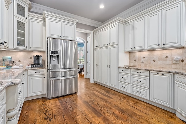 kitchen featuring stainless steel fridge with ice dispenser, dark hardwood / wood-style flooring, white cabinetry, and crown molding