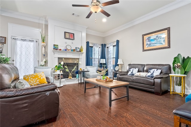 living room featuring crown molding, visible vents, dark wood-type flooring, a high end fireplace, and ceiling fan