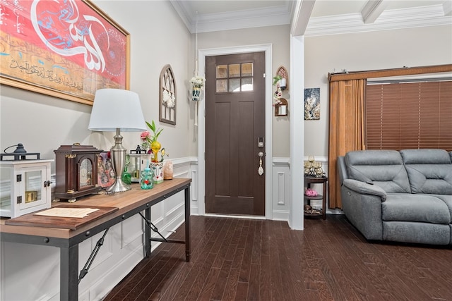 foyer entrance with dark wood-style floors, wainscoting, and crown molding