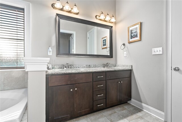 856 Violet Ln, Opelika, AL 36801 - bathroom featuring double vanity, a bath, and baseboards