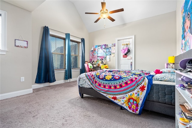 carpeted bedroom with lofted ceiling, a ceiling fan, and baseboards