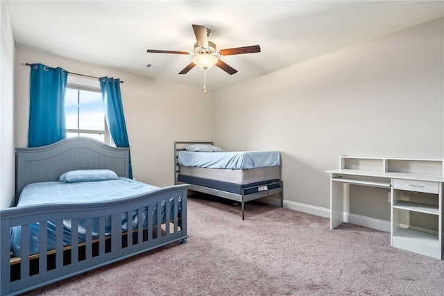 carpeted bedroom featuring visible vents, ceiling fan, and baseboards