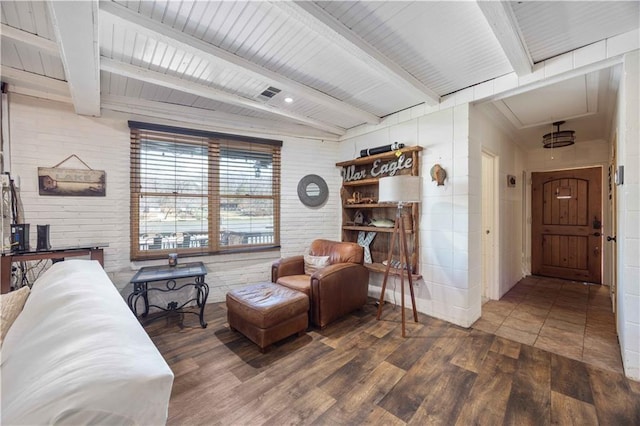 1701 Lee Road 353, Valley, AL 36854 - living room featuring wood finished floors, brick wall, beam ceiling, and attic access