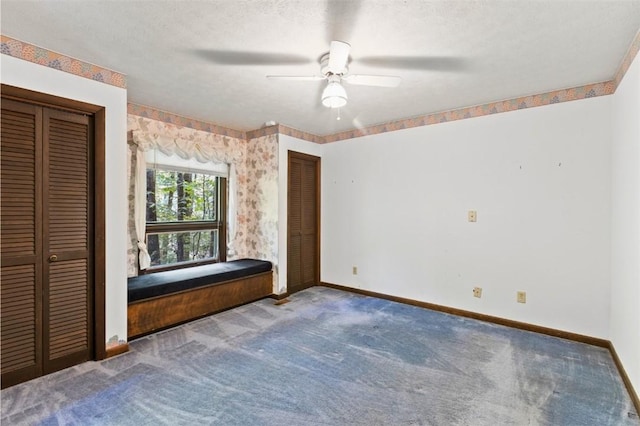 711 Oak Knoll Cir, Auburn, AL 36830 - carpeted bedroom featuring two closets and ceiling fan