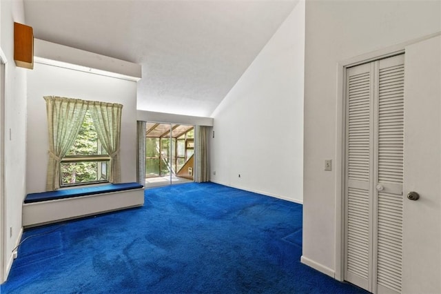 711 Oak Knoll Cir, Auburn, AL 36830 - unfurnished living room with carpet flooring and vaulted ceiling