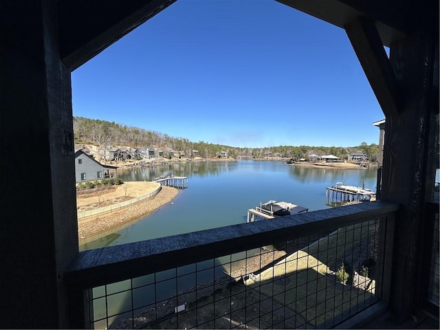 balcony with a boat dock and a water view