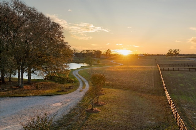 view of street with a rural view and a water view