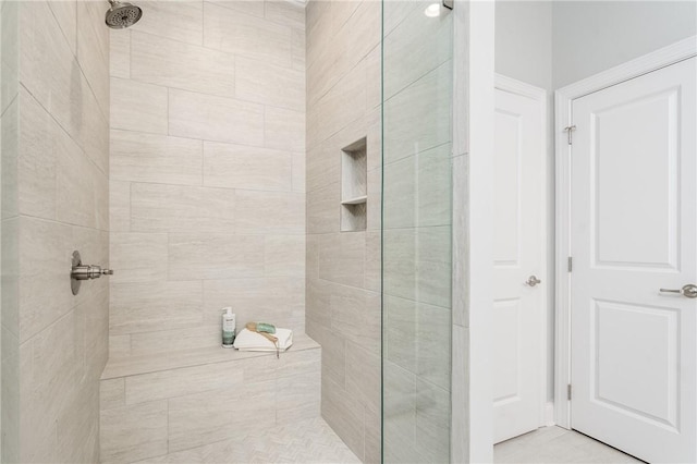 bathroom with a tile shower