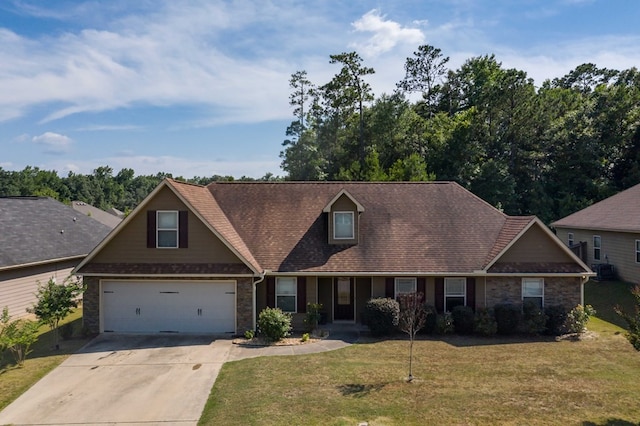 view of front of property with a front yard and a garage