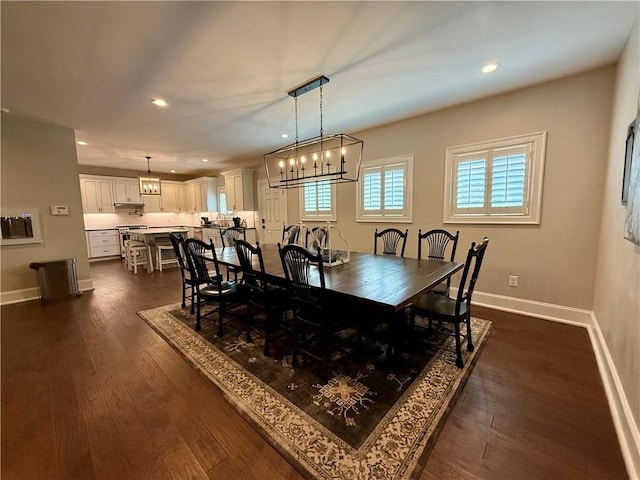 dining space with recessed lighting, baseboards, and dark wood finished floors