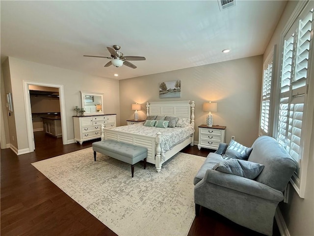 bedroom with dark wood-style floors, baseboards, a spacious closet, ceiling fan, and recessed lighting