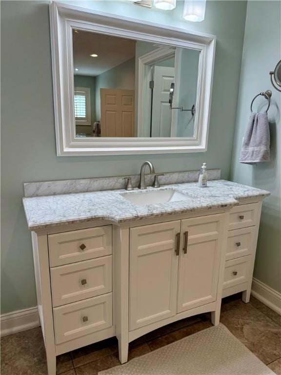 bathroom with baseboards and vanity