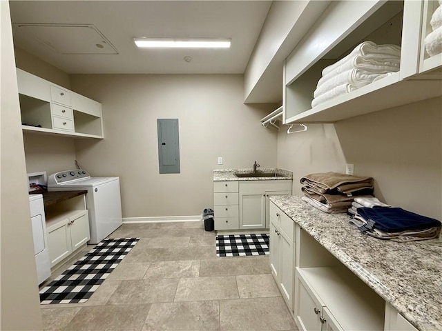laundry area with electric panel, baseboards, cabinet space, and washing machine and dryer