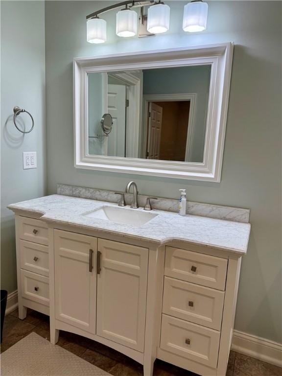 bathroom featuring baseboards, vanity, and tile patterned floors