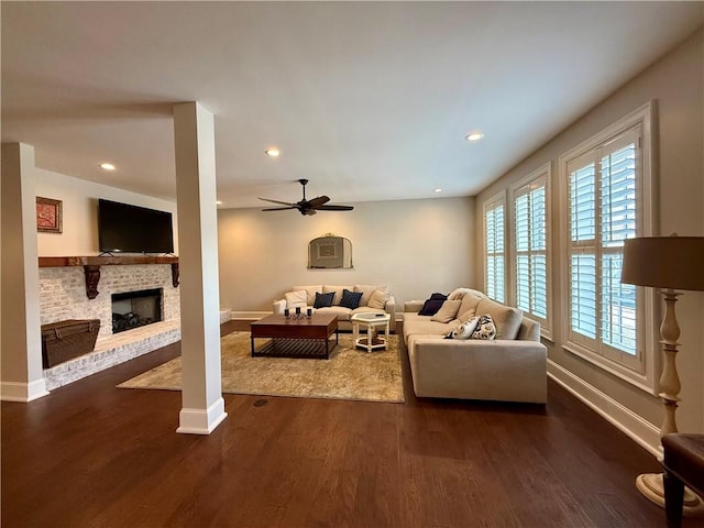 living area with plenty of natural light, a fireplace, baseboards, dark wood finished floors, and recessed lighting