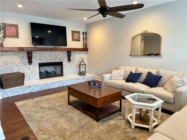 living room with wood finished floors, a ceiling fan, recessed lighting, and a fireplace