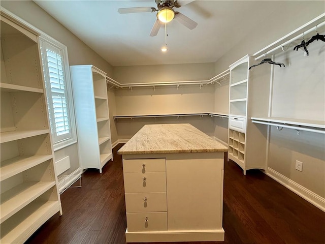 spacious closet with a ceiling fan and dark wood finished floors