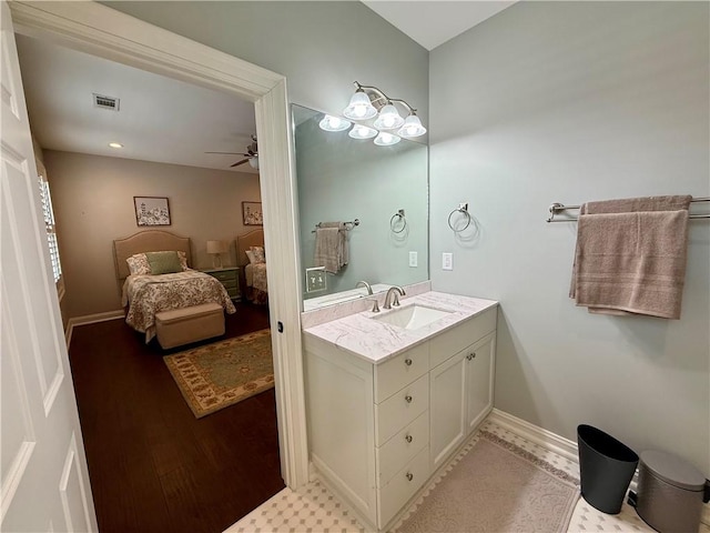 bathroom with a ceiling fan, vanity, and baseboards