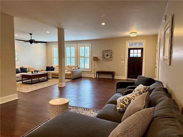 living area featuring baseboards, plenty of natural light, dark wood finished floors, and recessed lighting