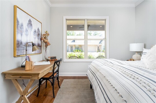 bedroom featuring dark wood-style flooring, crown molding, and baseboards
