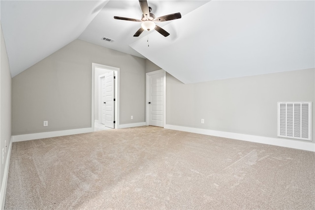 additional living space featuring carpet, visible vents, lofted ceiling, and baseboards