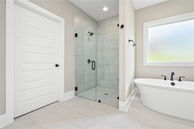 full bath with a stall shower, recessed lighting, baseboards, and a soaking tub