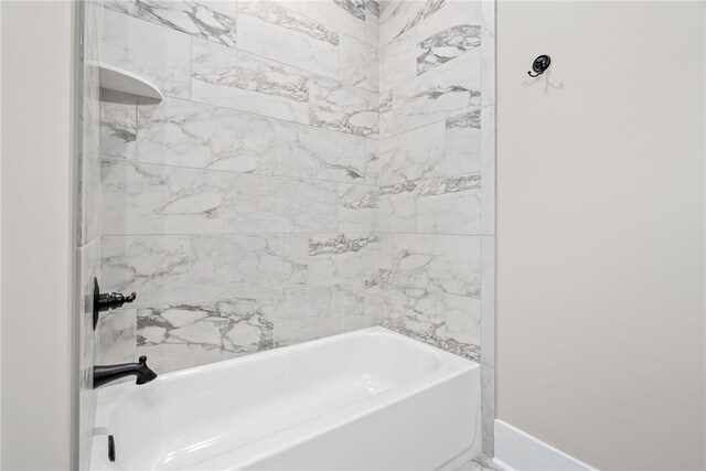 bathroom featuring shower / bathtub combination and baseboards