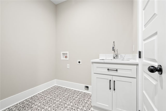 washroom featuring light tile patterned floors, baseboards, hookup for an electric dryer, washer hookup, and a sink