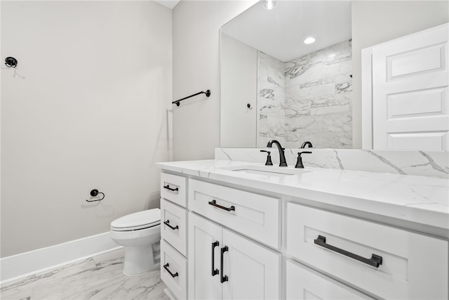 bathroom with toilet, vanity, baseboards, marble finish floor, and a tile shower