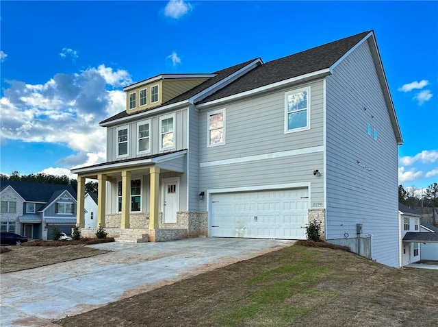 craftsman-style house with a porch, driveway, and a garage