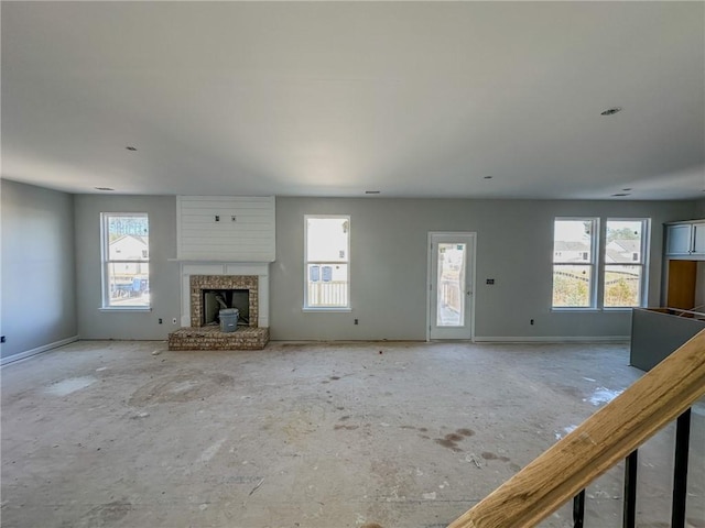 unfurnished living room featuring a stone fireplace