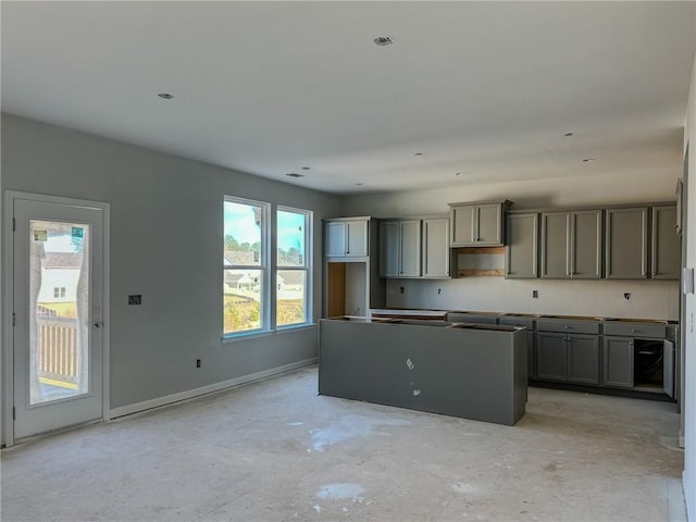 kitchen with a wealth of natural light, gray cabinetry, and a center island