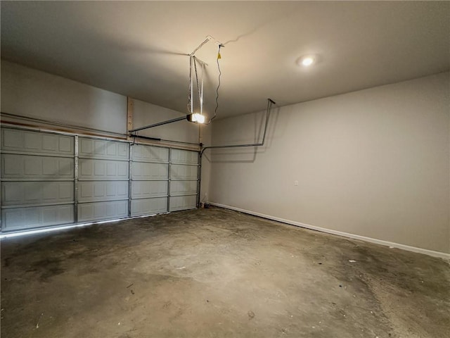 garage featuring a garage door opener and baseboards