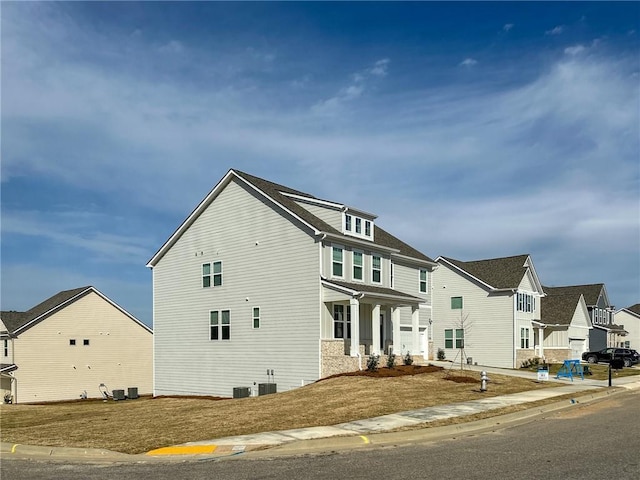 view of front of property featuring central air condition unit and a residential view