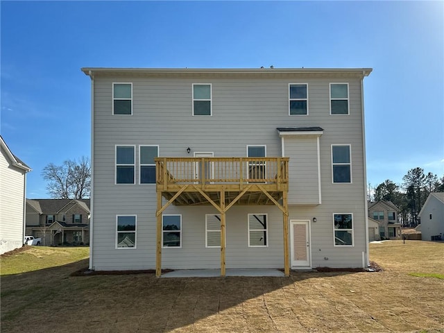 rear view of property with a yard, a patio area, and a wooden deck